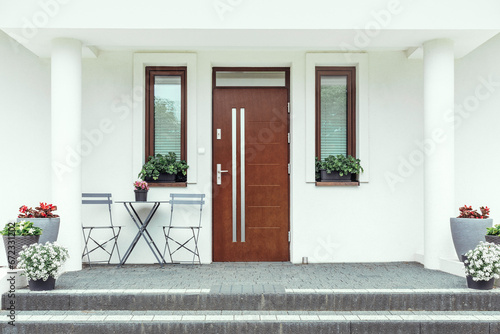 Designer entrance door to a country house. Modern design. luxurious exterior. Facade of a modern building with modern doors.