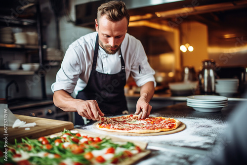 A Male chef makes pizza in a restaurant