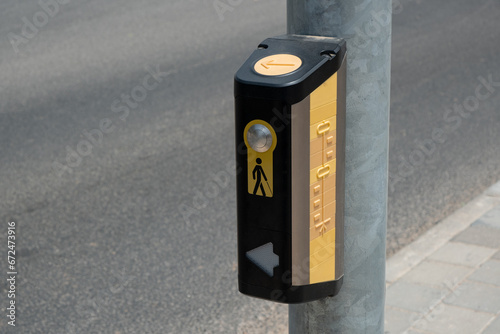 button, positioned at crosswalks. tactile button, mounted on a pole, serves as an essential tool for blind individuals to safely cross the road