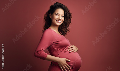 Expectant mother tenderly touching her baby bump.