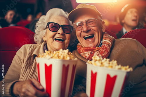 Happy senior couple with popcorn at cinema