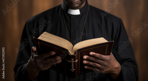 Pastor with a Bible in his hand during a sermon. The preacher delivers a speech. Senior priest standing with Bible
