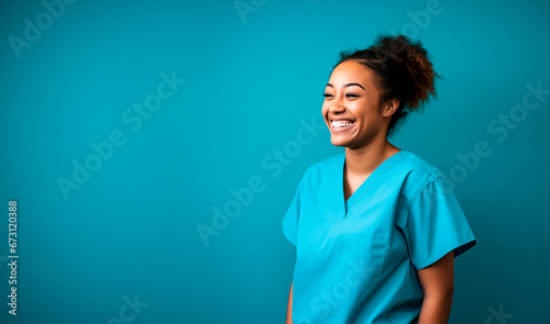 Nurse or healthcare professional looking happy and smiling. Colored woman wearing scrubs nurse uniform. Shallow field of view with copy space.