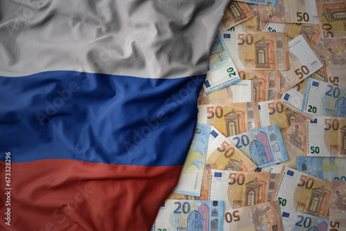 colorful waving national flag of russia on a euro money background. finance concept