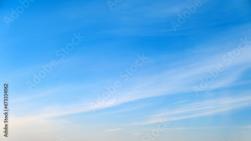White cirrus and stratus clouds in a blue daytime sky