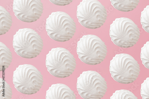 White zephyr marshmallows pattern on light pastel pink background