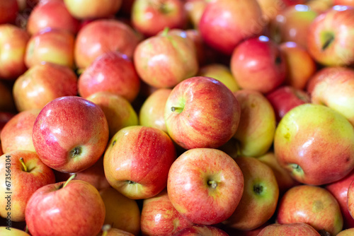 Detail of a bushel of ripe red apples on display in the market.