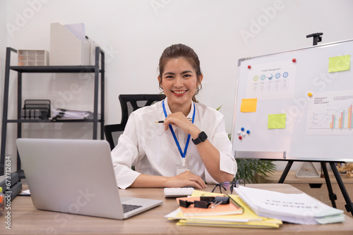 Confident smile businesswoman young asian, happy asian female employee, company sale marketing manager, sit in office