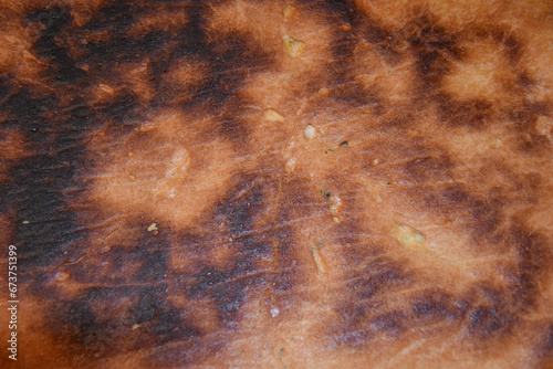 Burned bread crust texture. Overcooked bread crust close-up