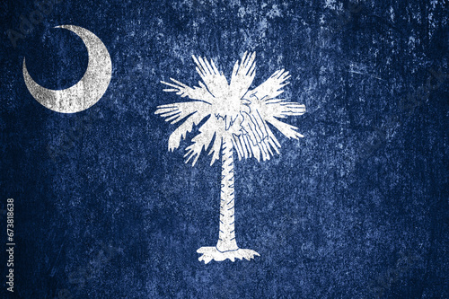 Close-up of the grunge South Carolina state flag. Dirty South Carolina state flag on a metal surface.