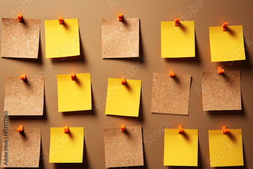 Yellow sticky notes pinned on board in rows