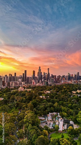 Vertical aerial view of a bright sunset sky over the skyline of Melbourne, Australia