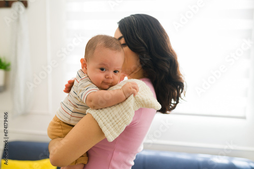 Mom burping her newborn baby after feeding