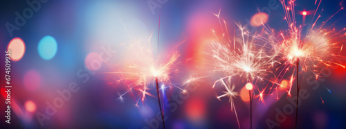 Sylvester New Year, New Year's Eve 2024 party event celebration holiday greeting card - Closeup of sparkling sparklers and bokeh lights in the background