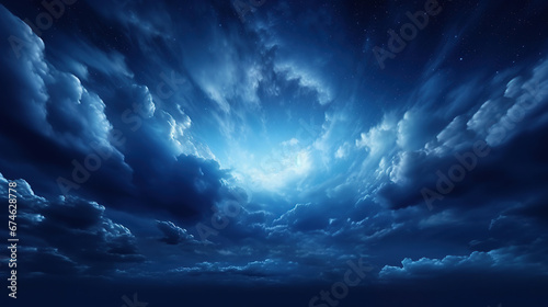 Black dark blue night sky with stars. White cumulus clouds. Moonlight, starlight. Background for design. Astrology, astronomy, science fiction, fantasy, dream. Storm front. Dramatic.