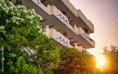 Apartment building with greenery on the sunset.