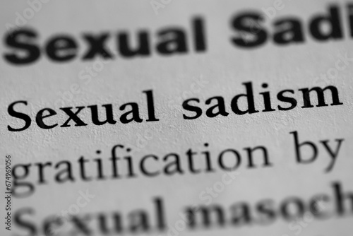 sexual sadist, psychological sexual fetish or obsession terminology printed in black on white paper close-up. medical treatment and therapy. fetish of inflicting pain