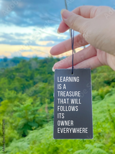 Inspirational life quote concept with blurred nature background - Learning is a treasure that will follow its owner everywhere