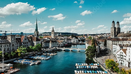 Scenic view of a riverbank with multiple sailboats and motorboats in the waters in Zurich