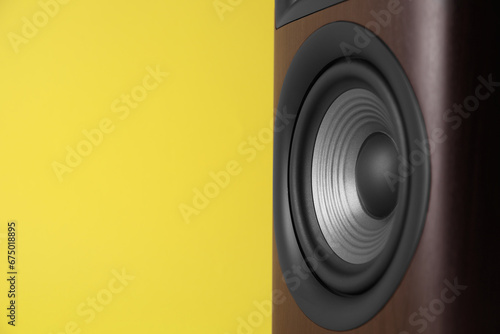 One wooden sound speaker on yellow background, closeup. Space for text