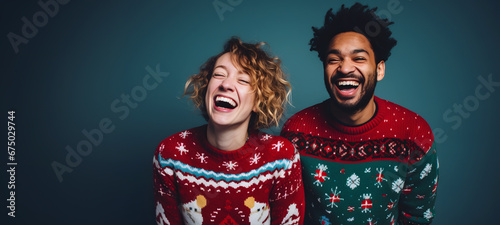 beautiful happy couple with Christmas sweaters and a blue background celebrating the Christmas and New Year holidays
