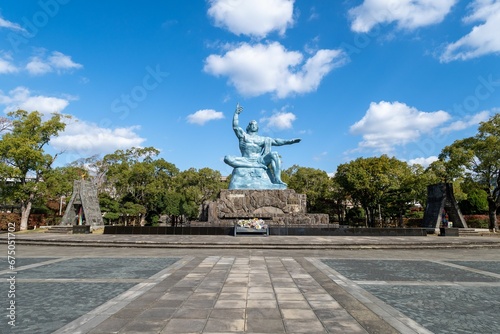 Peace Statue in the Peace Park, Nagasaki surrounded by lush trees