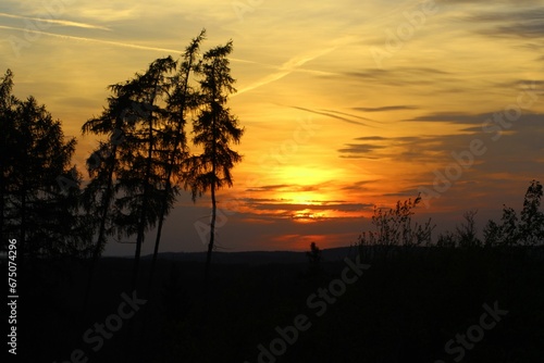 Sauerland, Germany - Dramatic pink and orange sunset with forested hills in distance