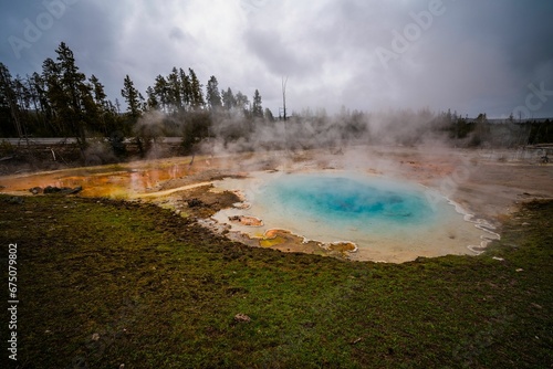 Picturesque view of a vibrant hot spring in Yellowstone National Park.
