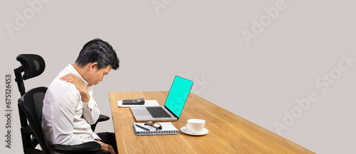 Overworked male office worker suffering from neck pain after had a long day at work.