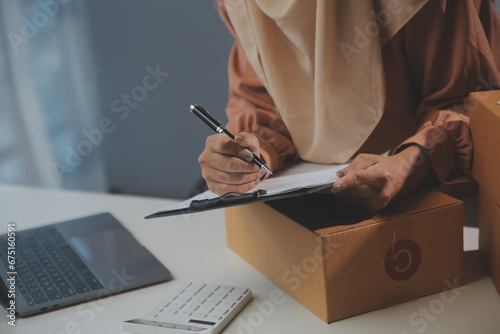 Starting small businesses SME owners female entrepreneurs Write the address on receipt box and check online orders to prepare to pack the boxes, sell to customers, sme business ideas online.