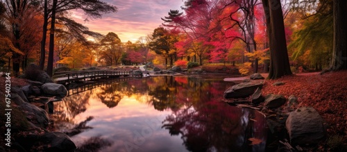 In autumn the landscape transforms with vibrant hues as the water glistens reflecting the beauty of nature Trees sway in the gentle breeze grass remains lush and green and the leaves create