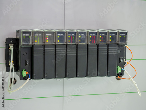 Programmable logic controller. Industrial electrical equipment. Logic controller with leds. Electrical appliance hangs on wall. Programmable controller for production automation. Power tech