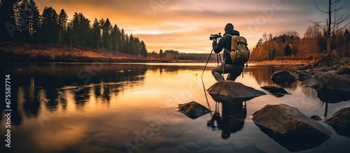 A man photographer on a beautiful lake.