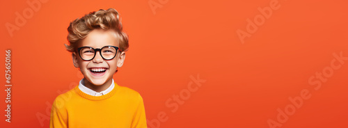 Portrait of happy kid smiling on bright colors studio background with empty copyspace, Cheerful little boy having fun