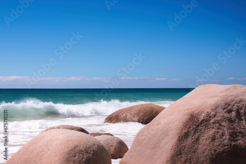 Beach and big rocks in sunny day with seascape and blue sky background. High quality photo