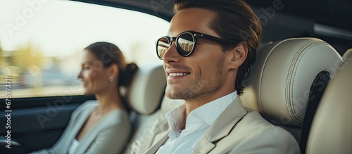 The successful businesswoman traveled with her family in a luxurious white car enjoying the window view while the man and woman couple in glasses were attending a teacher s presentation on 