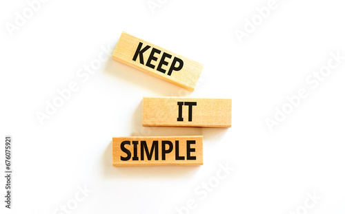 Keep it simple symbol. Concept word Keep it simple on beautiful wooden block. Beautiful white table white background. Business motivational keep it simple concept. Copy space.