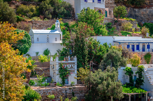 A church, a dovecote and other whitewashed buildings in Kardiani village, Tinos, Cyclades, Greece.
