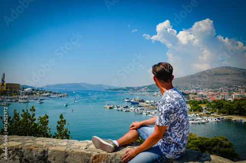 person sitting on a rock