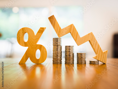 Percentage model and down arrow with coin stack. Key concepts for success, methods, systems of raising or lowering Fed interest rates to correct inflation concepts.