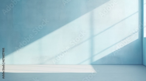 Abstract light blue background, perfect for product presentations. Shadows and light from the window on the cement wall Morning light enters through the diagonal window.