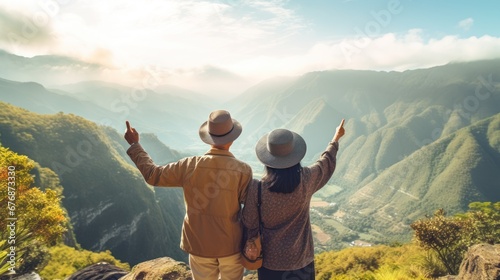 Couple tourists pointing at a vacant lot with a beautiful view in front, couples with nature