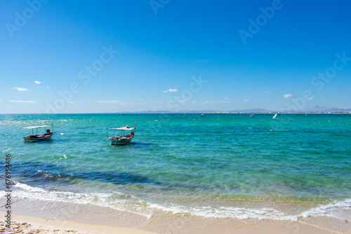 Hammamet Tunisia, Beach and boats on shallow water, view on Mediterranean sea 