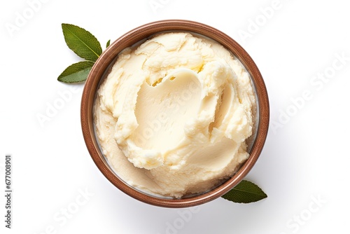 Top view of a bowl with isolated shea butter on a white background