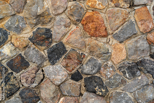 hard stones stack or modern rock wall dam and brown gray granite floor or black yellow stone jigsaw with concrete on top view for strong background or texture wallpaper with architecture construction