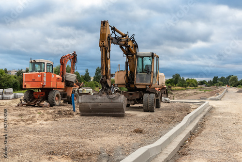 Excavator working on the construction of a new road in the city