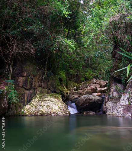 Calm Pond at the End of a Silky Water Stream Surrounded by Dense Jungle