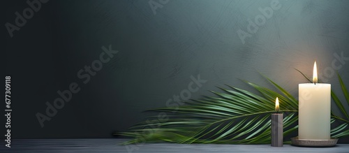 Catholic symbolism of Ash Wednesday Lent and Holy Week with cross palm leaf and candle Copy space image Place for adding text or design