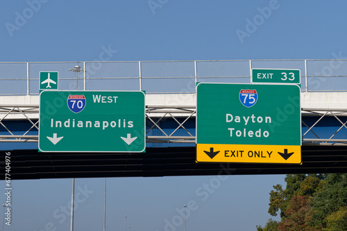 Signs on Interstate 70 for continuing west toward Indianapolis and the Dayton International Airport and exit 33 for Interstate 75 toward Dayton and Toledo, Ohio