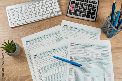 pen caluclator 1040 tax form on office desk, accounting concept